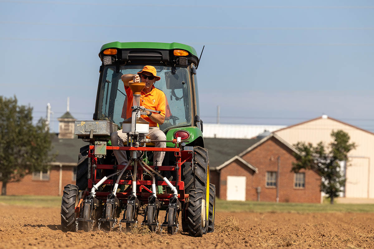 Brett Carver planting wheat seeds