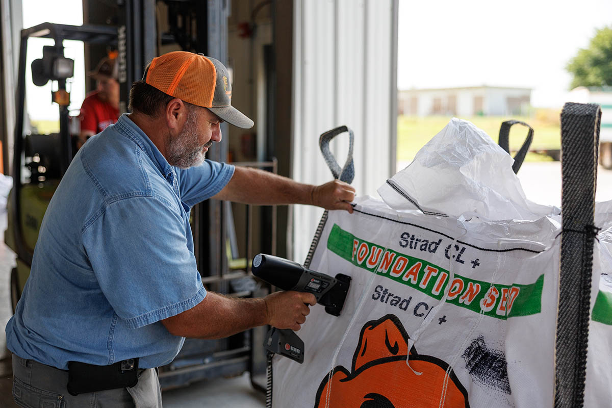 Jeff Wright stamping a seed bag