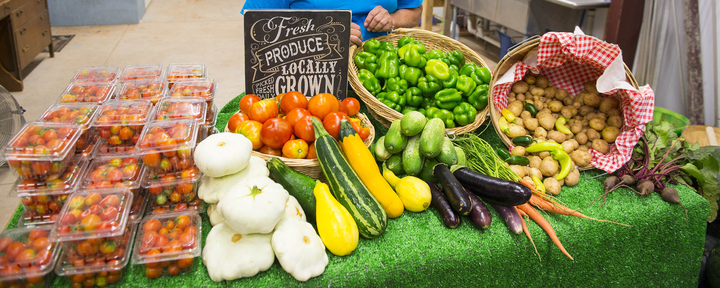 Produce laid out on a table at a farmer's market.