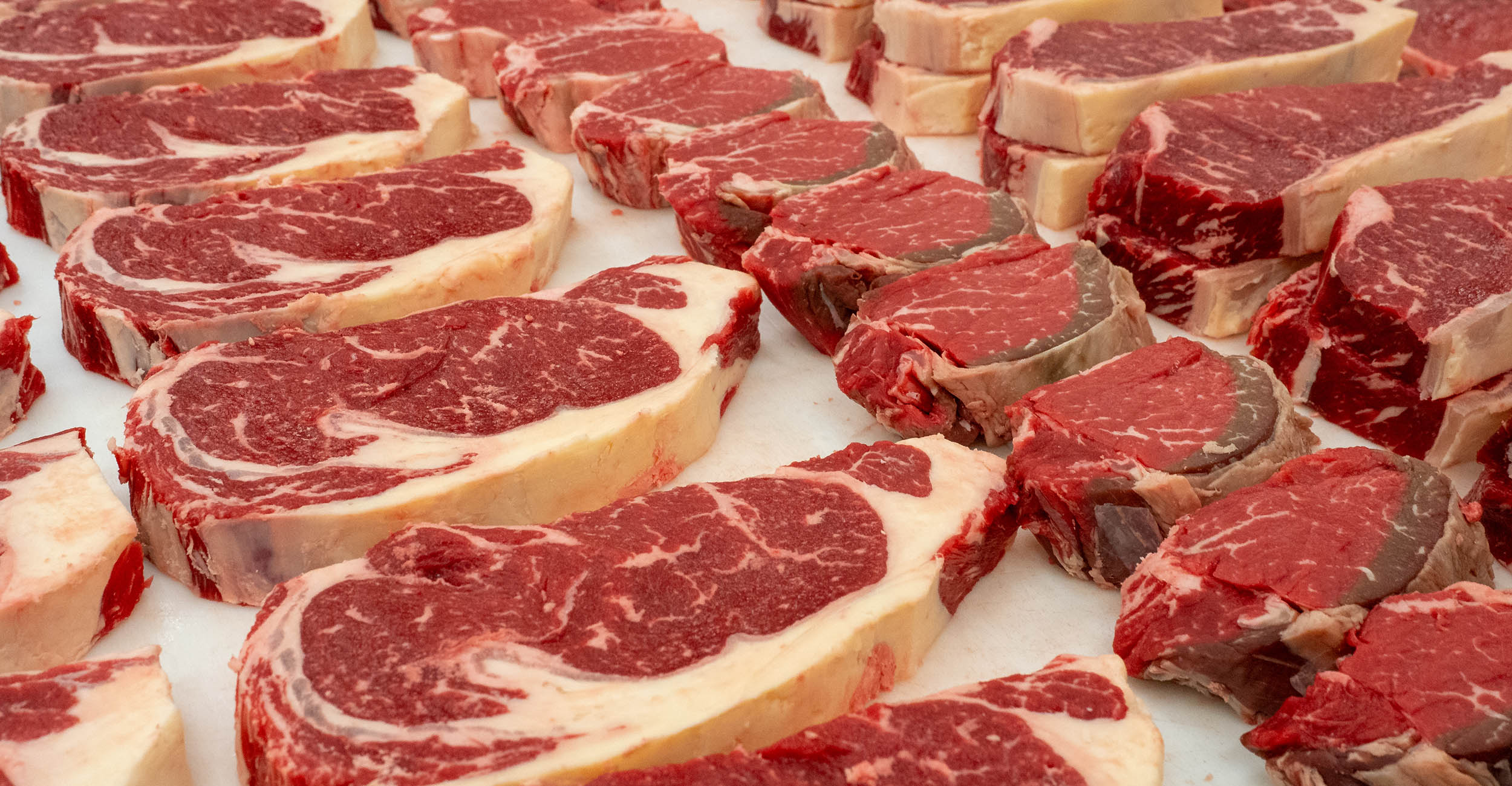 9-12-srcc-food-security-banner.jpg Raw steaks lined up on a counter