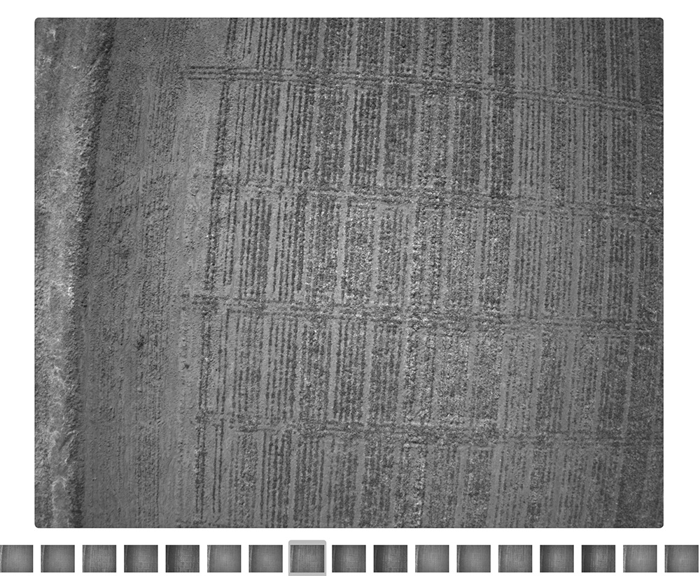 A black and white aerial shot of a field.